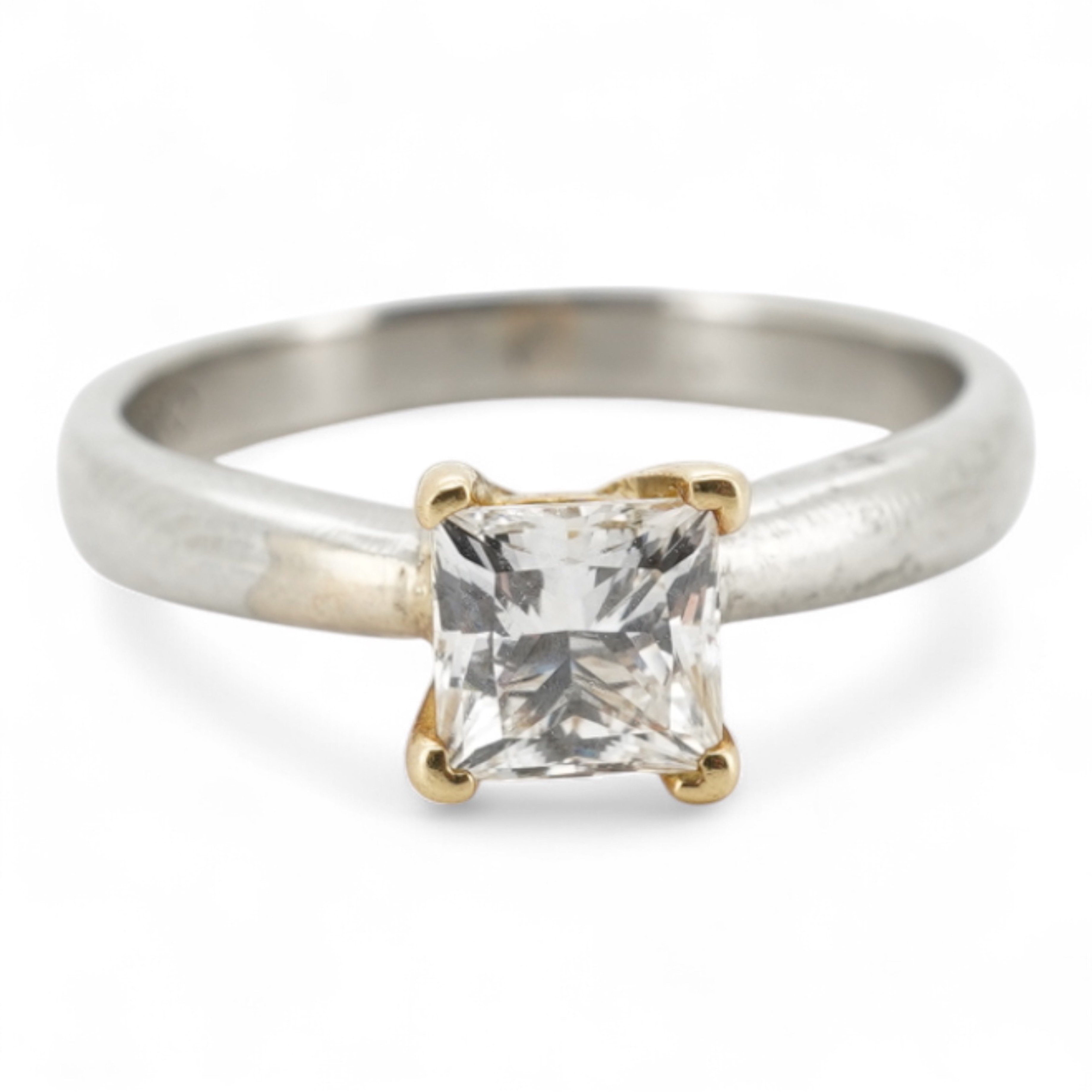 A diamond ring, claw-set with a princess-cut diamond weighing approximately 0.58 carats, mounted in platinum, size F1/2, British hallmarks, gross weight approximately 2 grams